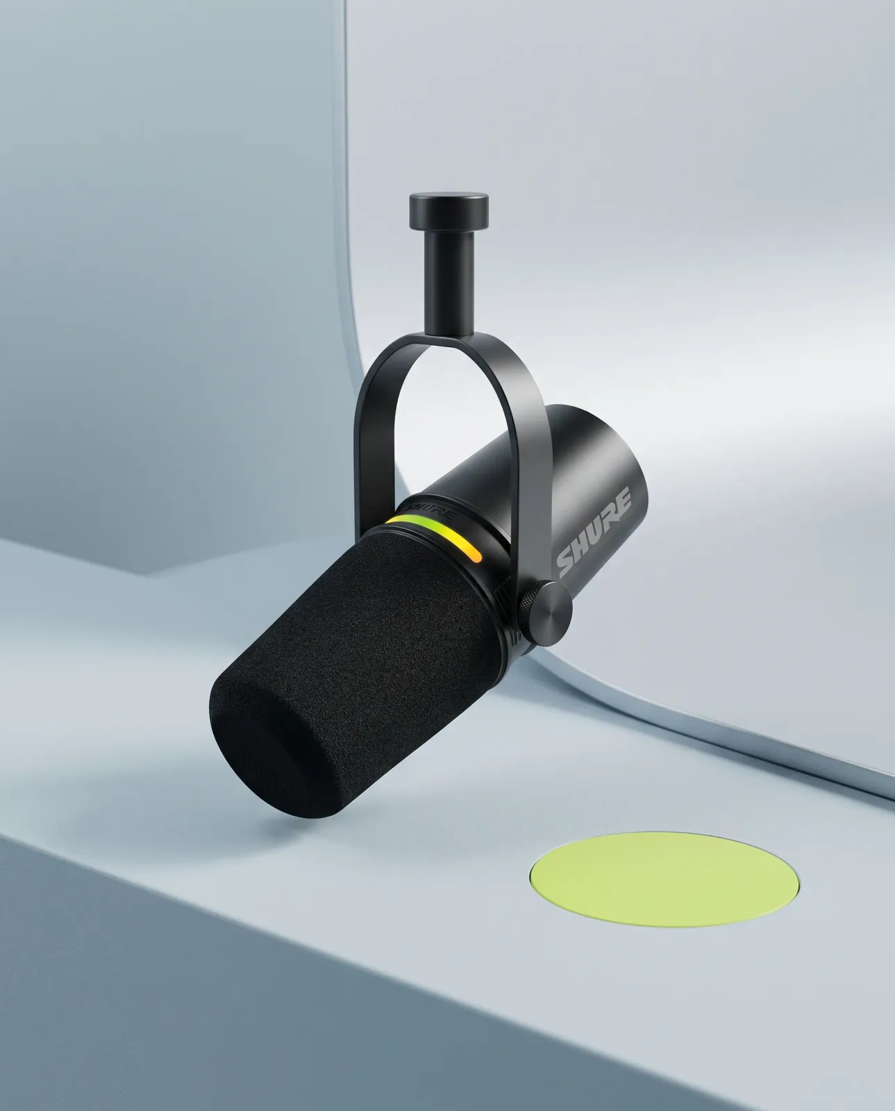 The same black Shure MV7+ microphone in a pale blue soft-minimal studio with a lime accent.